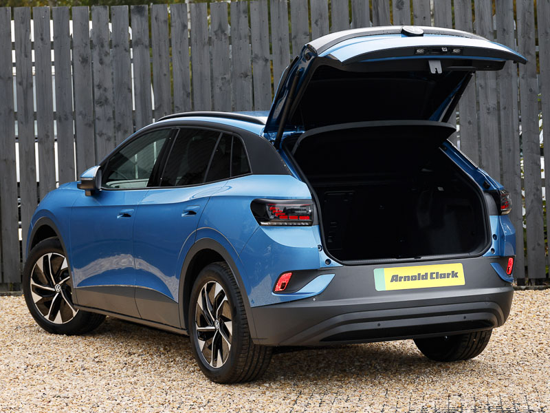 A blue VW ID.4 parked up from the rear with boot lid open