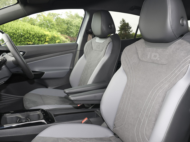 Inside the front of the VW ID.5's cabin showing the passenger and driver seat with a side on view of the steering wheel